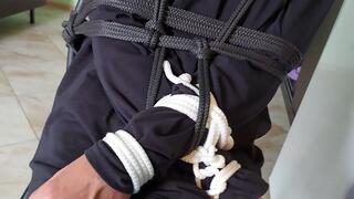 Sofi tied to a chair with black and white ropes_Gelen_Tel