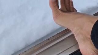 Naughty foot playing with the pedal & making snow dirty