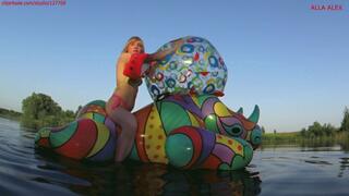 Alla rides on an inflatable rhinoceros and plays with a large beach ball and deflates the beach ball!!!