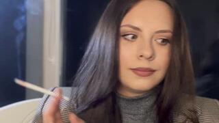 Smoking long white cigarette on classic stylish look