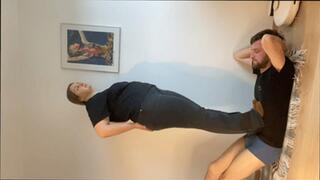 Heavy boots trampling through t-shirt - vertical