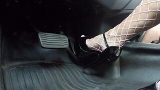 Shiny black stripper heels and fishnets pounding the pedal