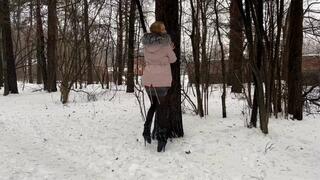 a girl walks through the winter forest in extremely high heels ballet boots