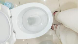 Barefoot Girl Desperately Pissing in the Toilet at Home