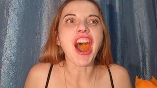 The mouth engulfs the fruit, tearing and pulverizing it