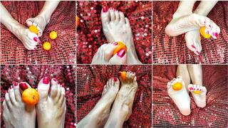The feet are playing with a tangerine