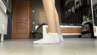 girl in a school uniform teases the viewer with her feet in socks, shows them close to the camera and plays with them, and then jerks off a toy