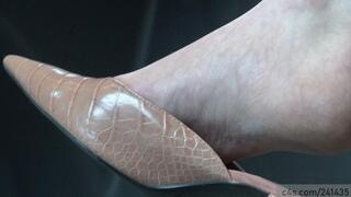 Beauty sexy feet in a candid dangling with elegant slipper sandals, perfect arched and heels