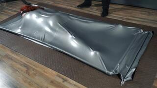 Flogging in a gray latex bed upside down with vibro and eyes closed