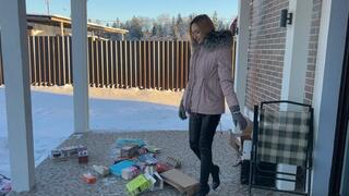 girl in high-heeled boots crushes cardboard and boxes and enjoys it