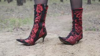 Long-legged Milf beauty in high heels, wearing beautiful boots walks through the mud and woods, smoking and stomping the raw mud with her sharp heels