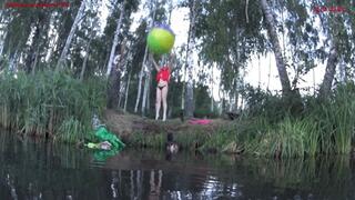 Alla plays with a large beach ball and blows it away while floating on the lake!!!