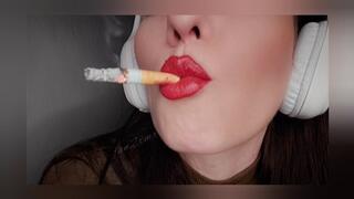 Close-up smoking with big headphones on