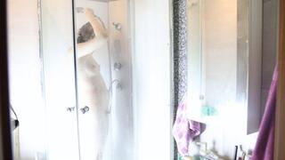 A girl caresses herself in the shower