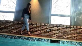 Reyna jumps in the Pool in Skinny Jeans and a Shiny Black Top