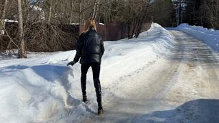 girl walks through the snowdrifts in high-heeled boots and falls deep into the snow