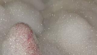 Playing with bubbles in the bathtub