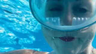 Underwater breathhold and bubble blowing fun in the swimming pool