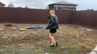 girl in her new vintage shoes walks through the mud and gets stuck in it so that she cannot pull her feet outU