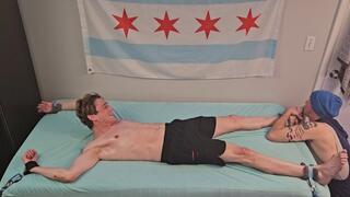 Colin Bryant playfully tickled on the bed