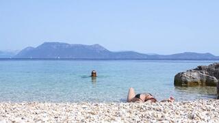 Anita pees standing right on Julia Julia and Anita in Greece on a public beach having fun