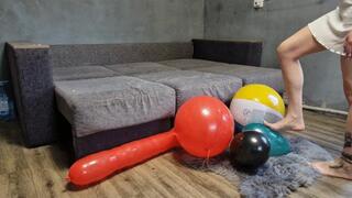 Alina with long toenails and hand nails plays and bursts inflatables