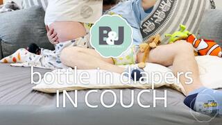 Bottle in diapers in couch