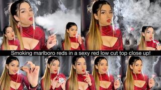 Smoking Marlboro Reds close up in a sexy red low cut top