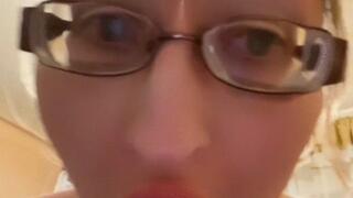 Girl in huge eyeglasses is yawning in the kitchen