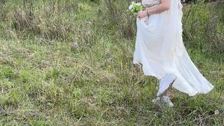 Bride sneaking up for a smoke break at her wedding - voyeur style capture