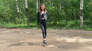girl in high heels walks along a muddy road and then goes down into a ditch with deep mud to get her shoes even more dirty and destroy her high heels
