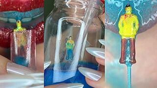 Tiny got trapped in a glass with blue liquid