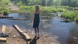 girl splashes her shoes in the water and then walks in sticky mud in wet shoes