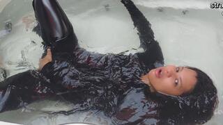 In the bathtub dressed in latex