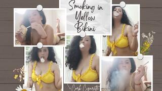 smoking two cork in yellow bikini and two different pose