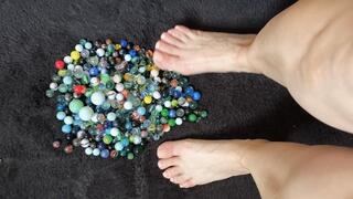 barefoot playing with glass balls