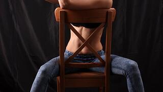 Anne: barefoot girl in black bra and blue skinny jeans, sitting on the chair with her hands tied up in front of her, poses for the camera (HD MOV)