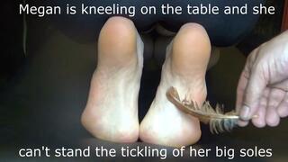 Megan is kneeling on the table and she can't stand the tickling of her big soles