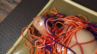 Hard colored bondage with vibro in latex vacuum bed