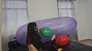 Marianna tries to pop balloons on top of her large GL 1200 balloon
