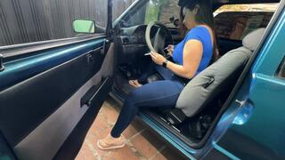 Karlotta smokes a cigarette in the Fiat Uno