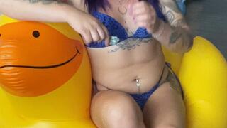 girl in swimsuit poping fliwer ballons