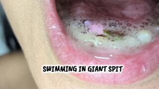 giant makes tiny man swim in his spit