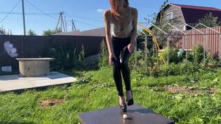 A girl in high-heeled shoes likes to beat eggs with her heels, she enjoys the fact that eggs crack under her heels