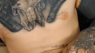 Tatted guy jerking his hard uncut cock and cumming