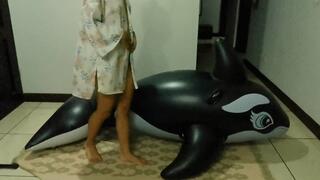 Akina humps and deflates her inflatable whale