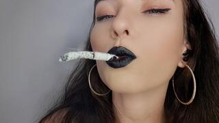 Sultry brunette with black lips smokes up close to your face: Miss Sara