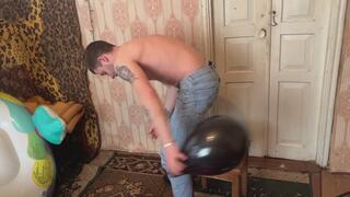 Jason pops balloons in torn blue jeans