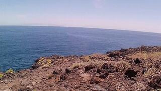 Couple is hiking naked near the coast and highway