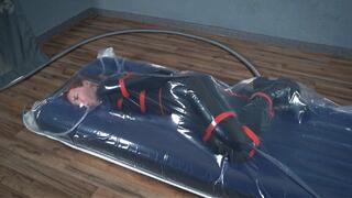 Bondage with red ropes of a special agent in a vacuum bag on an air mattress
